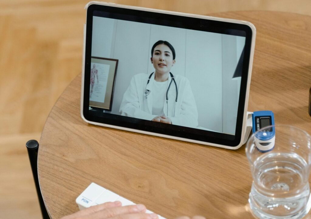 Elderly patient in video call with doctor using tablet. Healthcare technology concept.